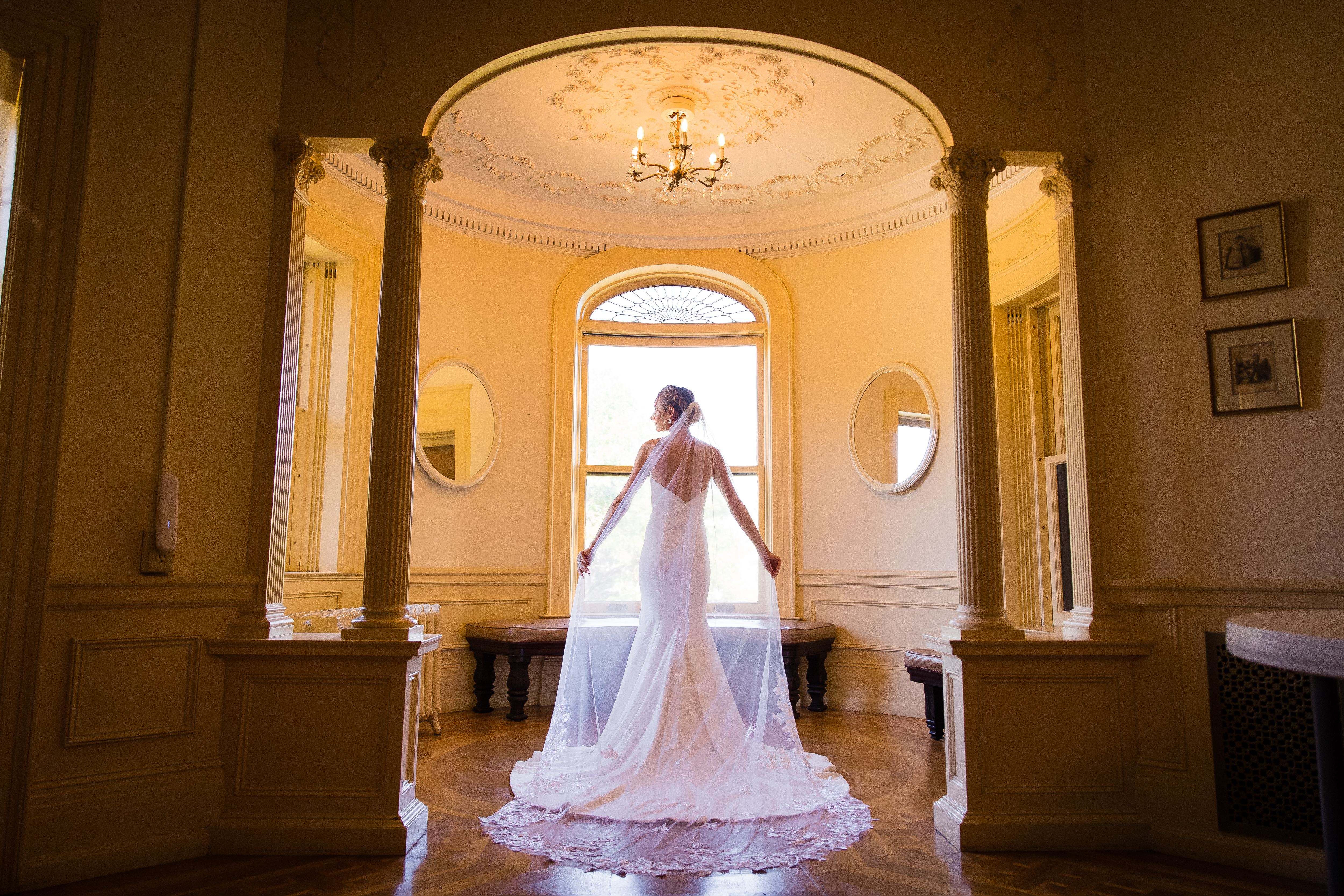 Bride wearing wedding dress poses in dressing room at Kilmer Mansion